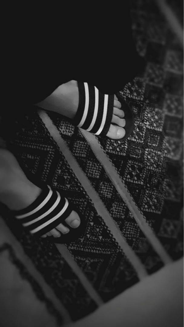 Child walking toward sunlight through trees