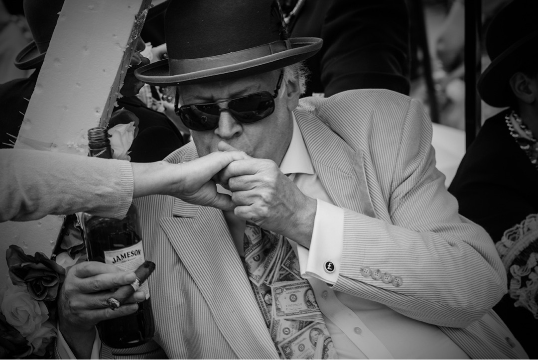Man in hat and suit, Jameson bottle