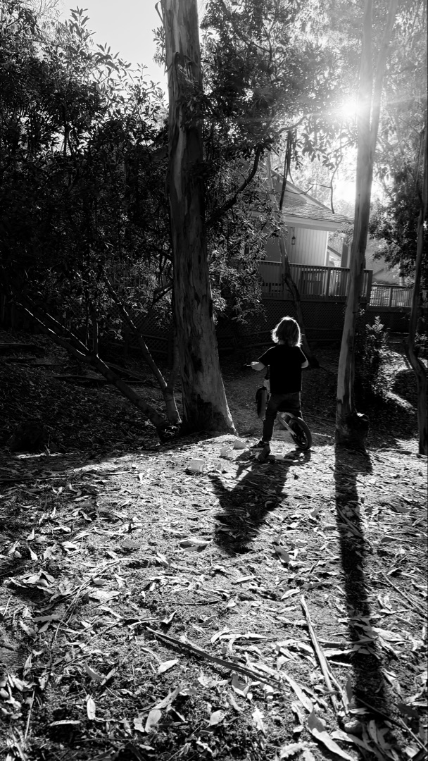 Child sitting by drainage tunnel