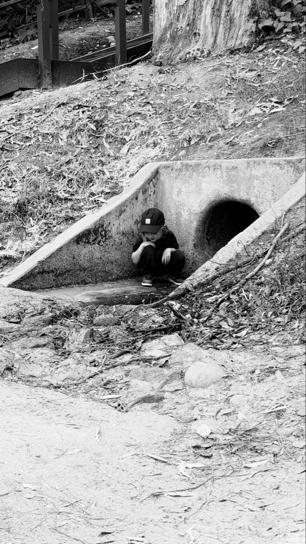 Child running down suburban street, stop ahead